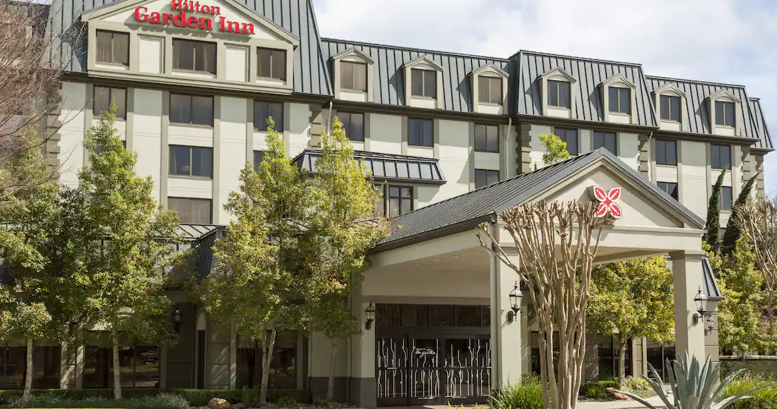Hilton Garden Inn hotel exterior with trees
